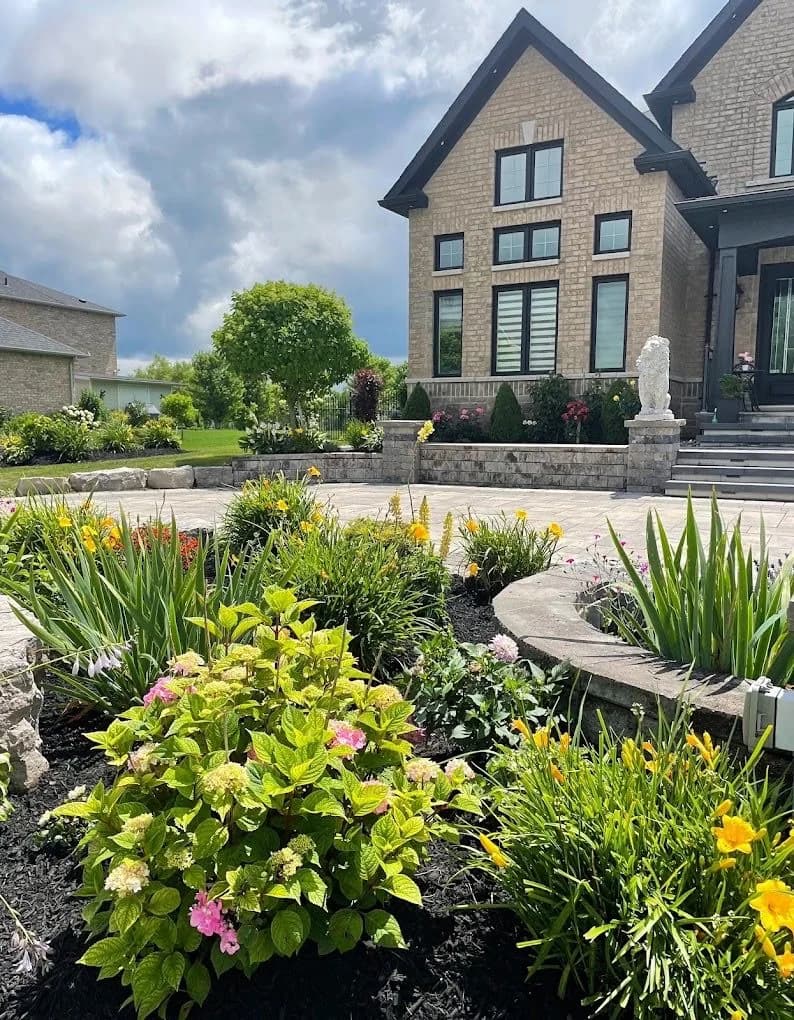 Layered flowering garden surrounding a curved front terrace