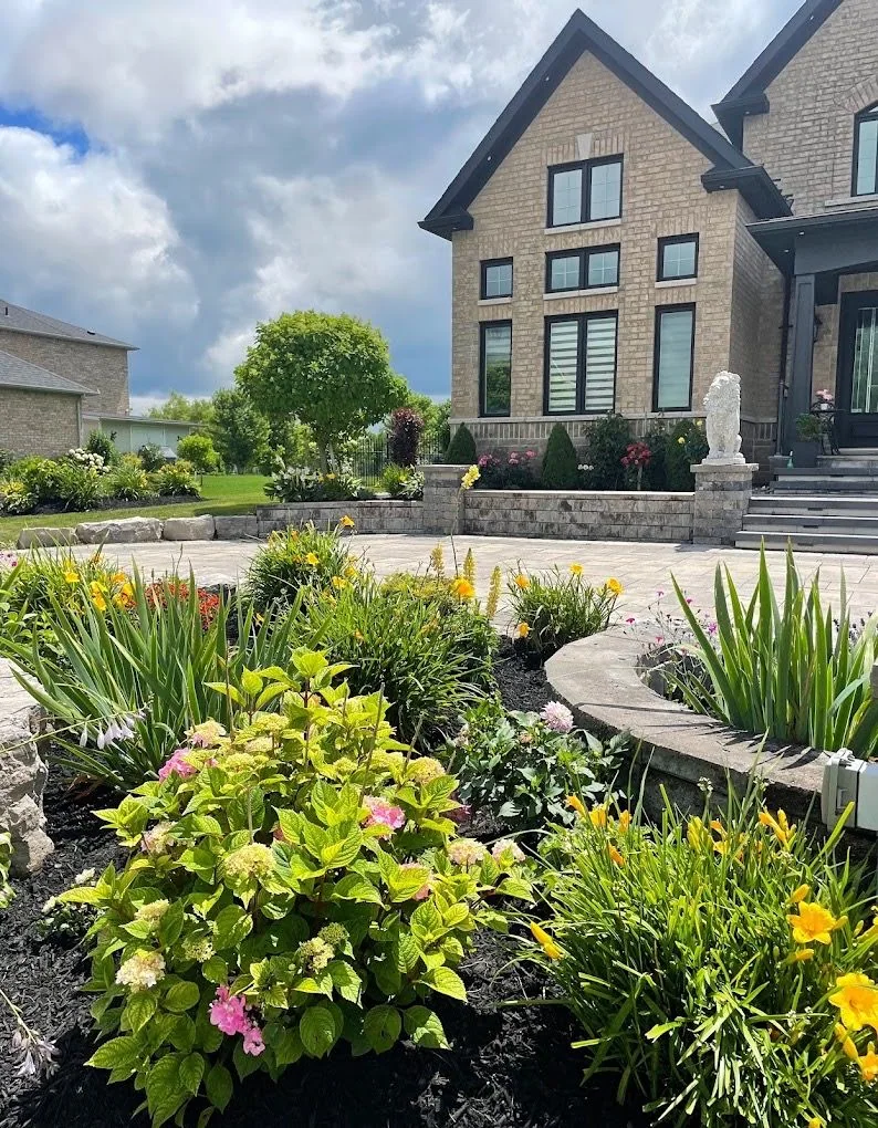 Layered flowering garden surrounding a curved front terrace