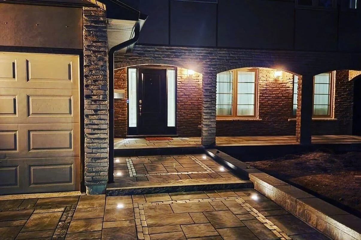 Low-voltage path lighting illuminating a detailed front entrance at night