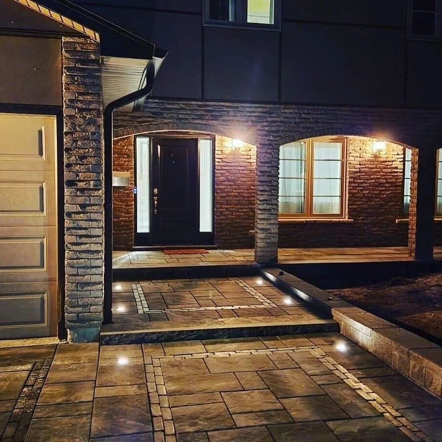 Low-voltage path lighting illuminating a detailed front entrance at night
