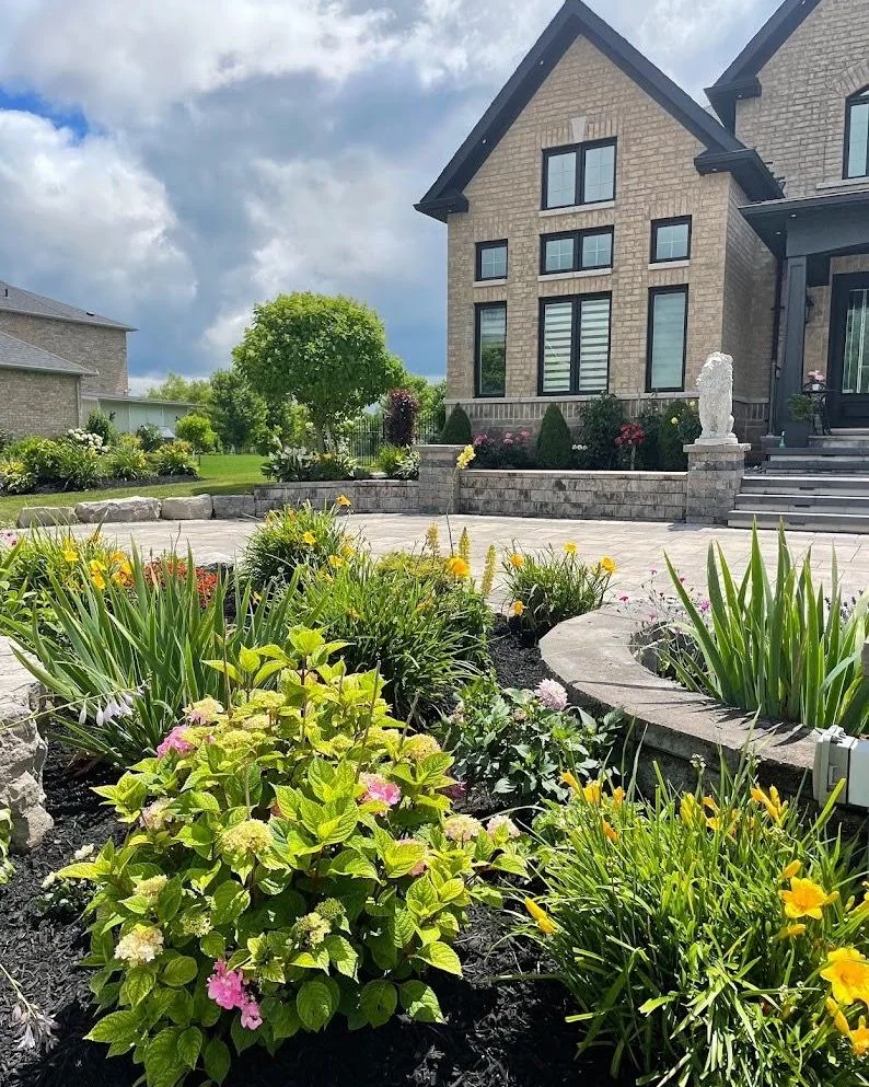 Layered flowering garden surrounding a curved front terrace