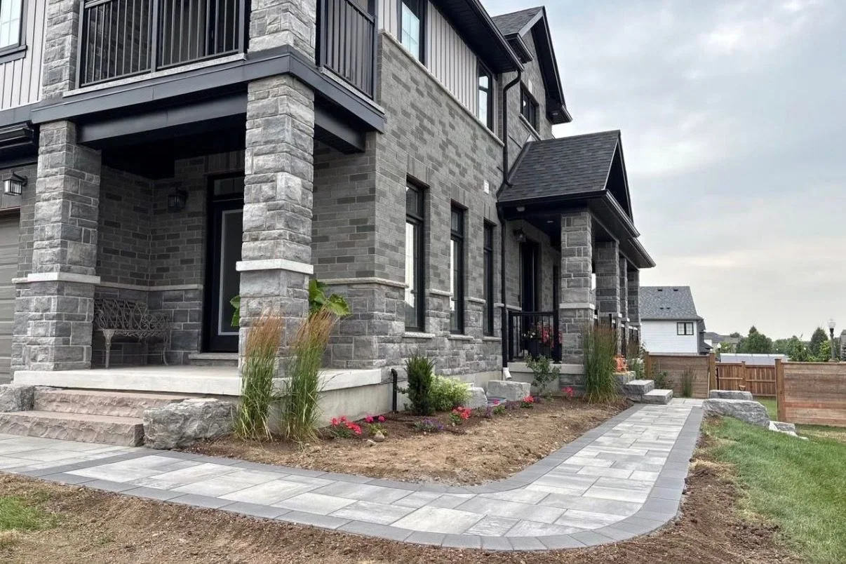 New paver walk and entrance planting during project completion