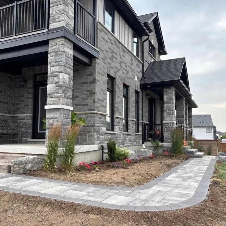New paver walk and entrance planting during project completion